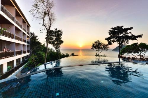 a hotel swimming pool with a view of the ocean at Dusit Buncha Koh Tao by Riya Group in Ko Tao