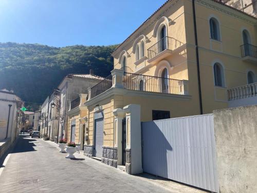 a row of buildings on a street with mountains in the background at Appartamenti Miravalle in Maratea