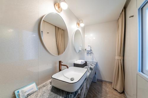 a bathroom with a sink and a mirror at Hotel Voll in Seoul