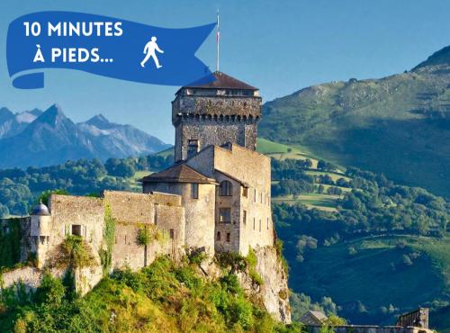 a castle on a hill with a man on top of it at Boudoir - Clim-Wifi-Twin-Gare in Lourdes