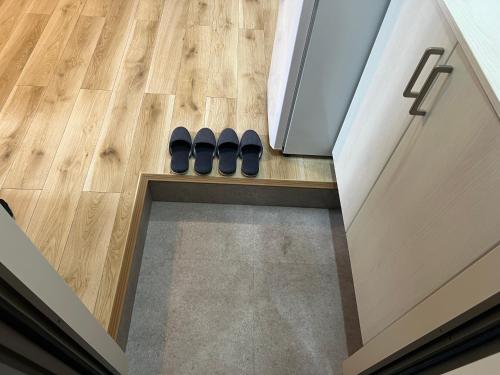 a pair of shoes sitting on the floor in a kitchen at Ikebukuro Area 41 NishiikeApartment in Tokyo