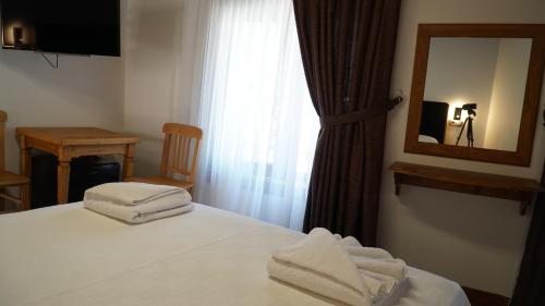 a hotel room with a bed with towels on it at Pikan Ephesus in Selcuk
