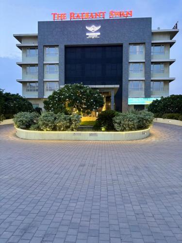 a building with a parking lot in front of it at The Radiant Swan in Dahej