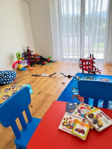 a room with two chairs and a table with toys on the floor at Willa Wioletta in Tylmanowa