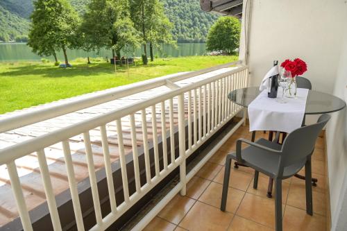 a balcony with a table and a view of a lake at Motel Plaza in Jajce
