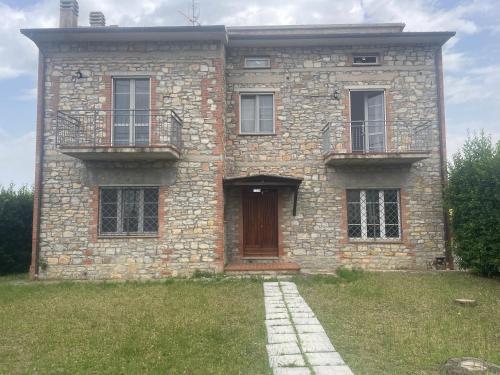 a large brick house with two balconies and a door at Sunshine in Sanfatucchio