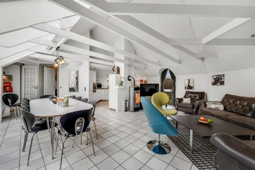 a living room with a couch and a table and chairs at Large Pool House With 6 Person Outdoor Spa 1015 in Ringkøbing