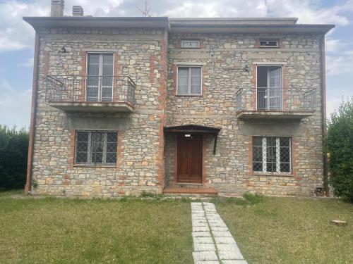 a large brick building with a door and windows at Sunshine in Sanfatucchio