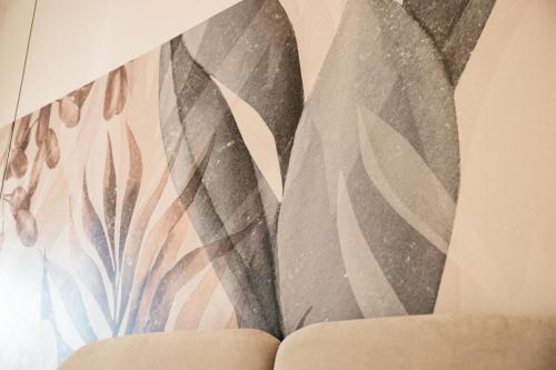 a wall mural of leaves on a wall at Bed and Breakfast Le Foglie in Altamura