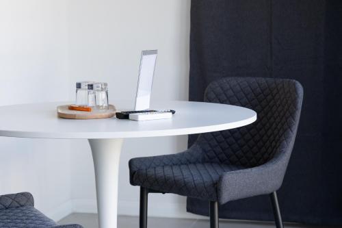 a white table with two chairs and a white table with at Villa Angela Suite in Taranto