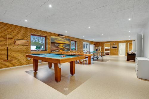 a room with a ping pong table in it at Large 30-Person Holiday Home With Pool And Spacious Activity Room - 5000 in Engesvang