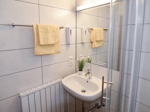 a white bathroom with a sink and a mirror at Schwarzwaldmädel-Ferienwohnungen in Todtnau