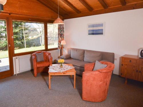 a living room with a couch and two chairs and a table at Schwarzwaldmädel-Ferienwohnungen in Todtnau
