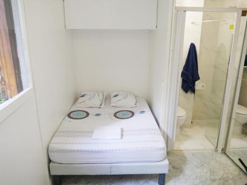 Cette petite chambre comprend un lit dans une salle de bains. dans l'établissement PARIS Tour EIFFEL, à Paris