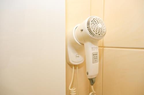 a hairdryer and a blow dryer on a wall at Motel Plaza in Jajce