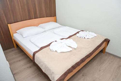 a bed with two white pillows on it at Motel Plaza in Jajce