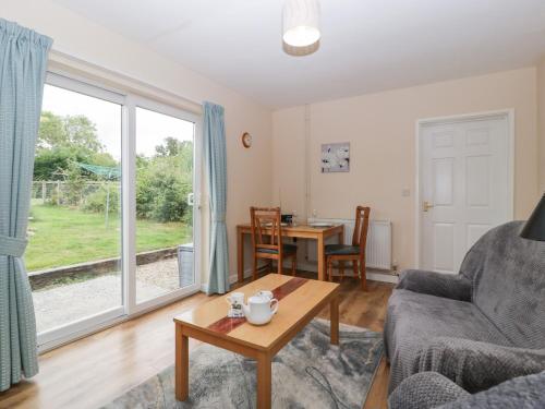 a living room with a couch and a table at The Turbles - Swallows Nest in Castlemorton