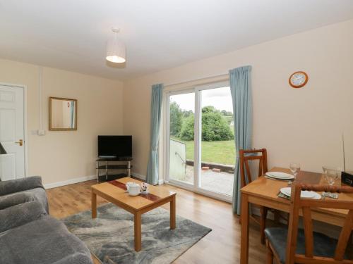 a living room with a couch and a table at The Turbles - Swallows Nest in Castlemorton
