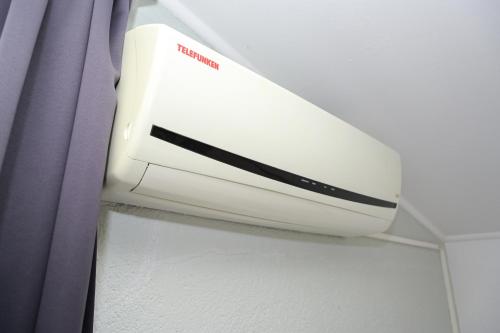 a air conditioner on a wall next to a curtain at Motel Plaza in Jajce
