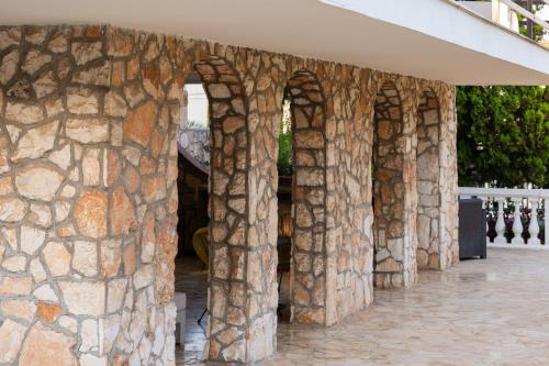 a stone wall with three arches on a building at Villa Angela Suite in Taranto