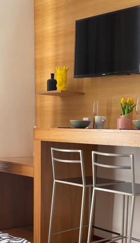 a bar with two stools at a counter with a television at Golem in Prague