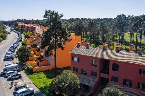 an overhead view of a building with cars parked in a parking lot at Caparica Golf & Beach Accomodation in Almada
