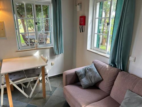 a living room with a couch and a table at Quinta Rosa Branca in Tavira