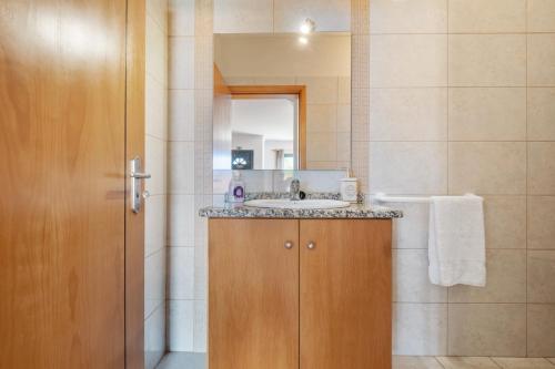 a bathroom with a sink and a mirror at Atlantic Ocean Breeze in Ponta do Sol