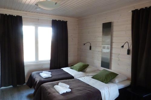 Ένα ή περισσότερα κρεβάτια σε δωμάτιο στο Tallusniemi Villas