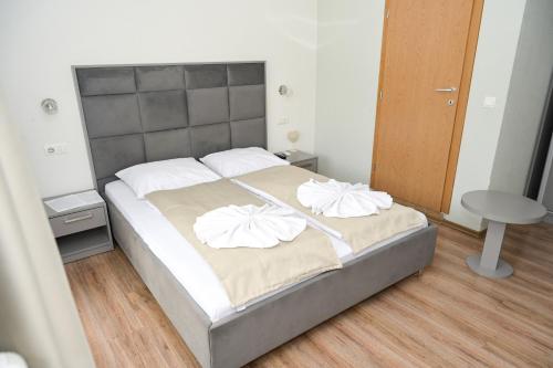 a bedroom with a bed with two pillows on it at Motel Plaza in Jajce