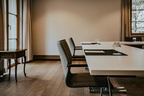 a dining room with a white table and chairs at Landgasthof Jagstmühle in Heimhausen