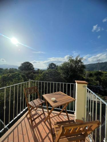 a table and two chairs on a balcony with a view at La Macchia in Santo Stefano di Magra