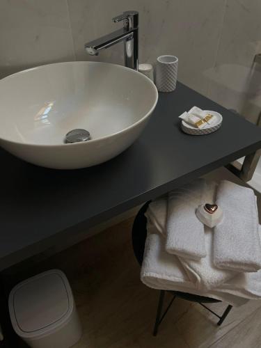 a bathroom with a white sink on a black counter at La Macchia in Santo Stefano di Magra