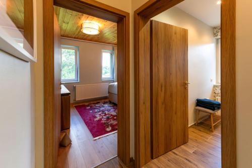 a hallway with a door leading to a room at reBORONA in Őriszentpéter