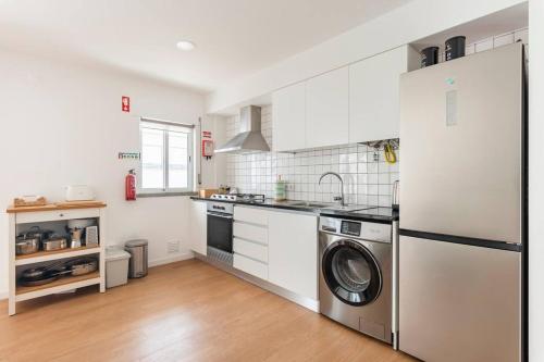a kitchen with a washer and dryer in it at Apartment Marysol in Nazaré