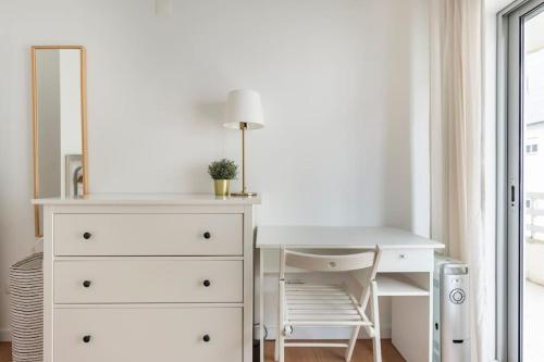 a bedroom with a white dresser and a desk at Apartment Marysol in Nazaré