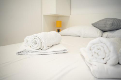 a pile of towels sitting on top of a bed at Villa Lucija in Milna