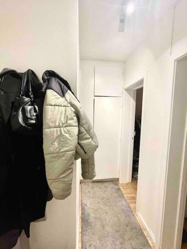 a hallway with a coat hanging on a wall at Two-room apartment in Stor København in Tåstrup