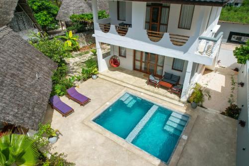 an aerial view of a house with a swimming pool at Mnana Beach Bungalows in Michamvi