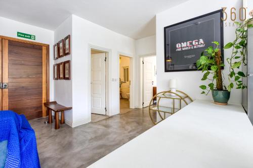 a living room with a flat screen tv on a wall at Designer 1BR home with private balcony in Gharghur by 360 Estates in Għargħur