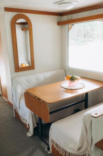 a small room with a table and a mirror at Atvases in Pērkone