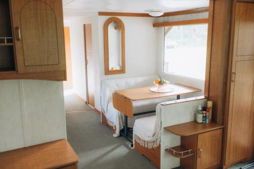 a small room with a table and a window at Atvases in Pērkone