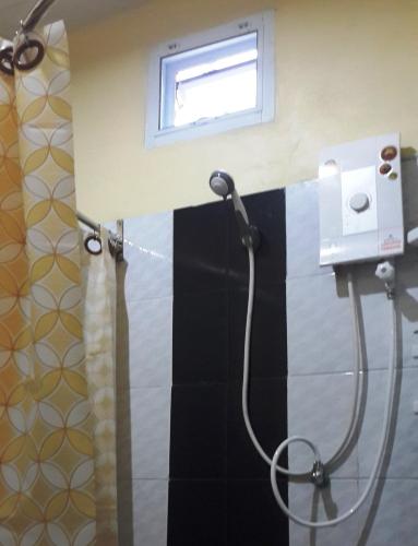 a shower with a shower head in a bathroom at No.17 @ Khaoyai in Mu Si