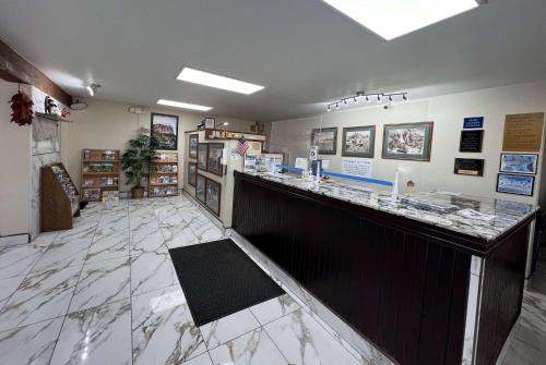 a restaurant with a counter in the middle of a room at Travelodge by Wyndham Truth or Consequences in Truth or Consequences