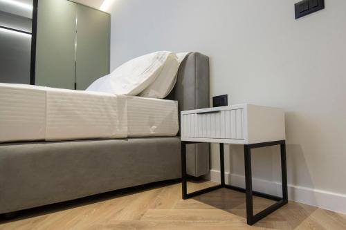 a side table next to a couch in a room at Mina Luxury Rooms in Tirana