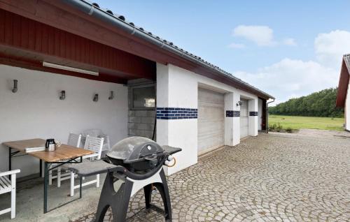 a barbecue grill on the patio of a house at 5 Bedroom Beautiful Home In Brovst in Brovst