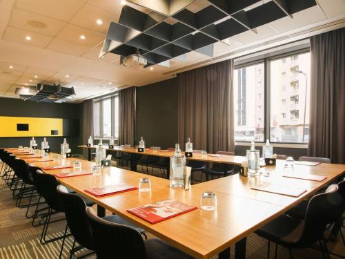 a large conference room with long tables and chairs at Ibis Sfax in Sfax