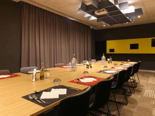 a large conference room with a long table with chairs at Ibis Sfax in Sfax