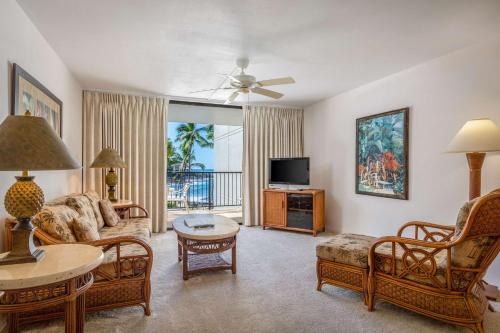 a living room with a couch and a tv at Aston Kona By The Sea in Kailua-Kona