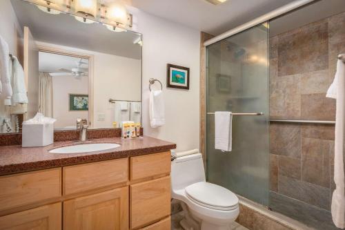 a bathroom with a toilet and a sink and a shower at Aston Kona By The Sea in Kailua-Kona
